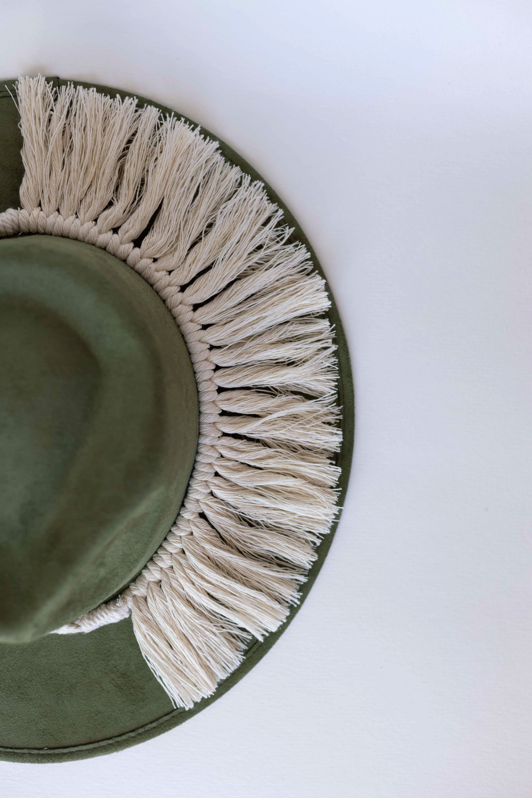 A cream colored hat accessory made in Mexico. Macrame stye “Tulum”