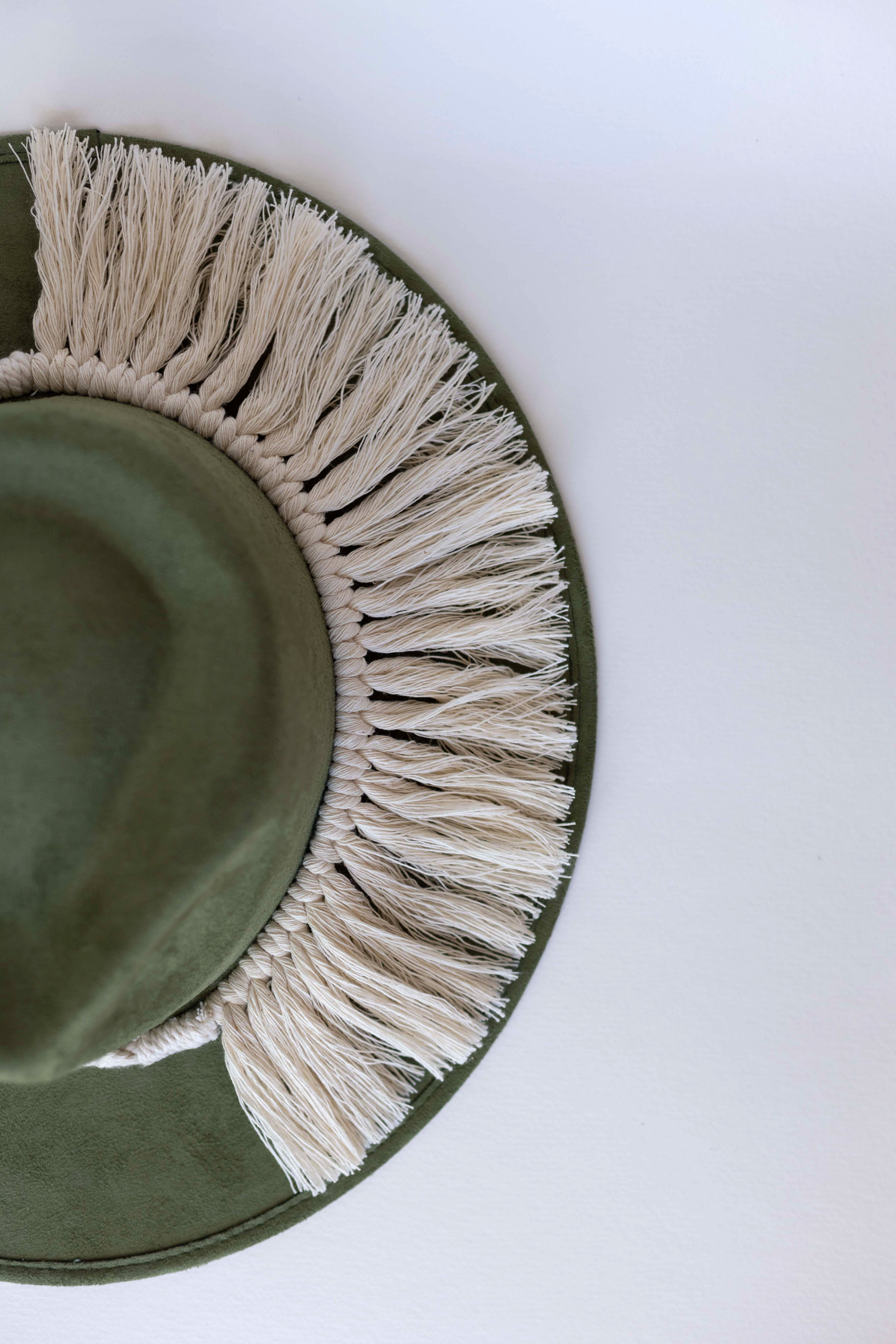 A cream colored hat accessory made in Mexico. Macrame stye âTulumâ