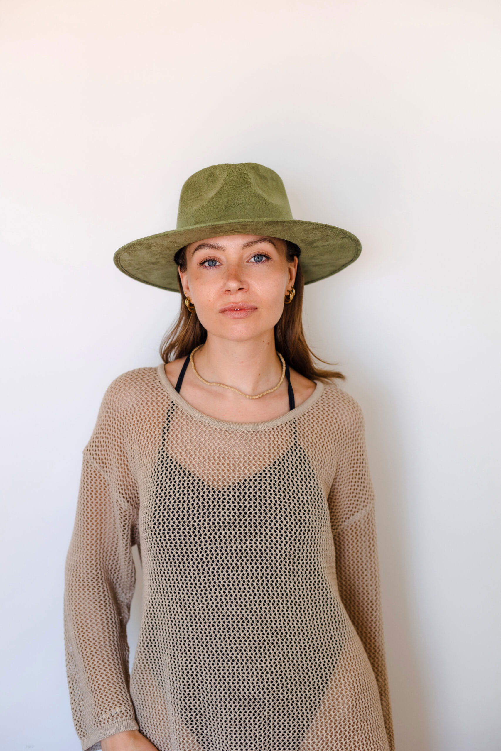 A pistache colored hat made in Mexico, made from synthetic suede front